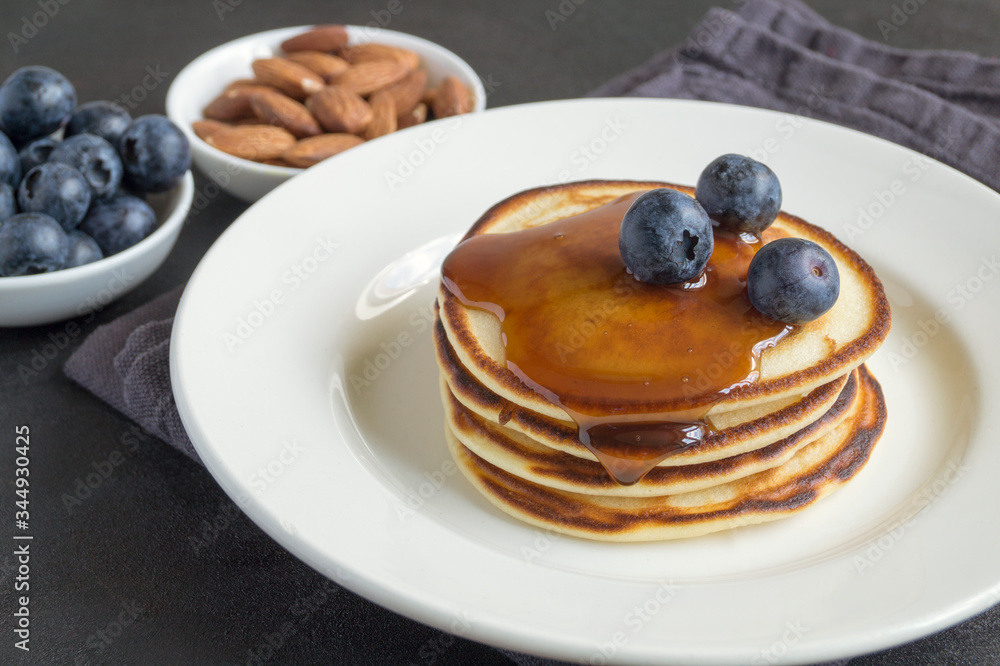 pancakes with syrup nuts and blueberries. pancakes with syrup nuts and blueberries.