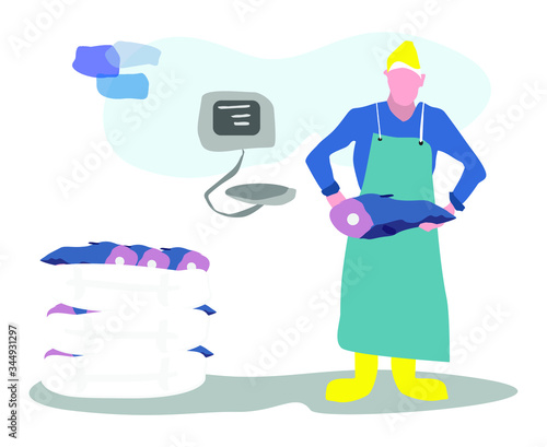 Male fishmonger wearing an apron with large fish taking them out of the boxes to be weighed
