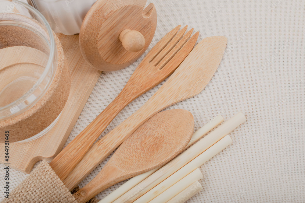 Reusable wooden kitchen utensils, fork, knife, spoon, wheat tubes, textiles. Zero waste concept, environmentally friendly items. Reusable wooden kitchen utensils, fork, knife, spoon, wheat tubes, textiles. Zero waste concept, environmentally friendly items.