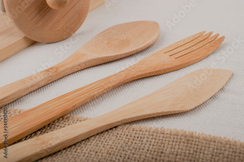 Reusable wooden kitchen utensils, fork, knife, spoon, wheat tubes, textiles. Zero waste concept, environmentally friendly items.