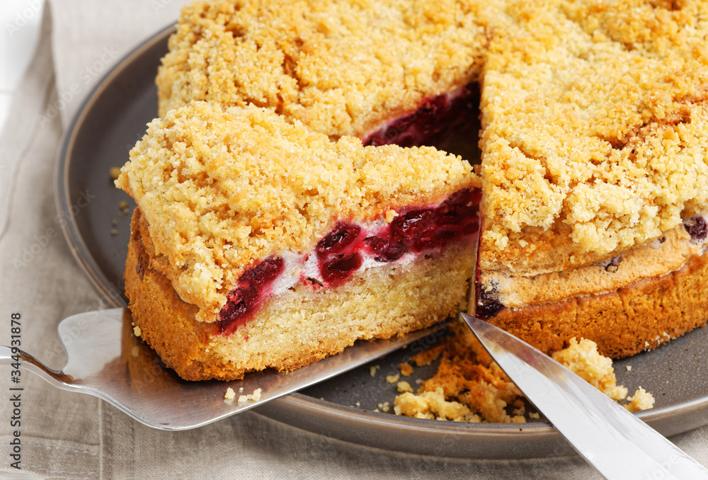 Closeup homemade cherry pie with crumbs on top. Shallow focus. Closeup homemade cherry pie with crumbs on top. Shallow focus.