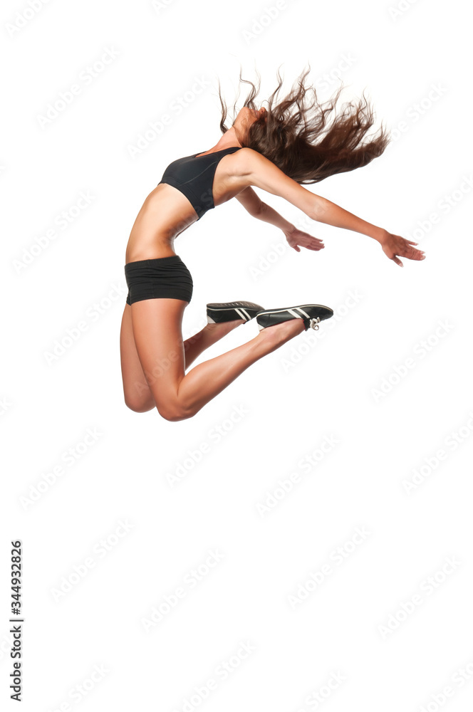 Fitness sporty woman jumping in studio. Full length shot of young attractive female on white background. Weight loss and well being concept