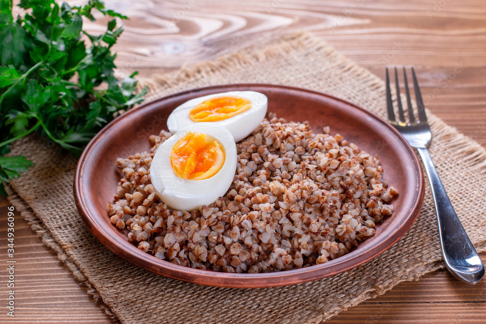 Buckwheat with vegetables on a wooden background. Buckwheat with vegetables on a wooden background.