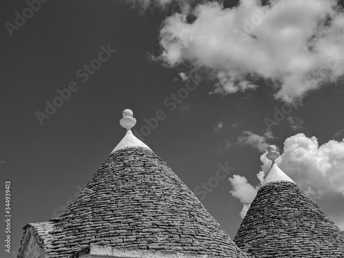 Black and White Photography of a Close-up of Trulli roofs.