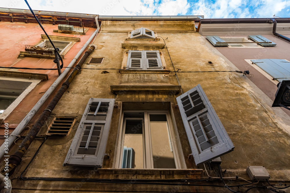 Close shot of an open window on the traditional italian facade
