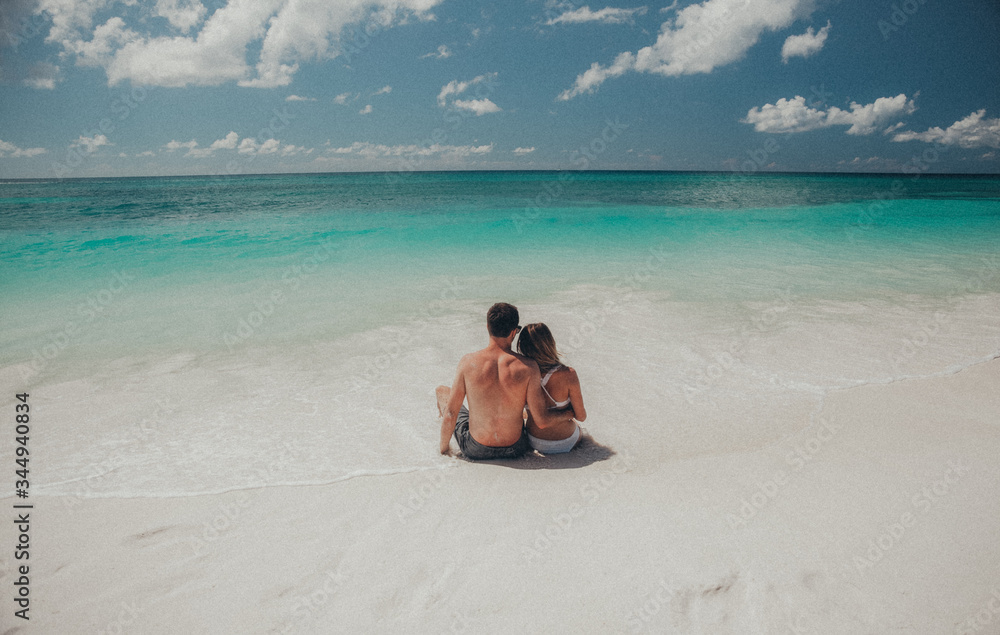 young couple sitting on the beach