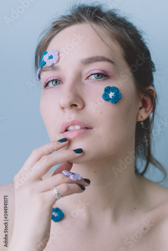 Girl with knitted blue flowers