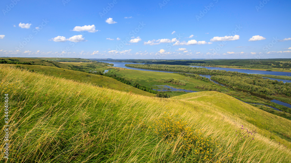 hills overgrown with grass and trees on the banks of the Vyatka River