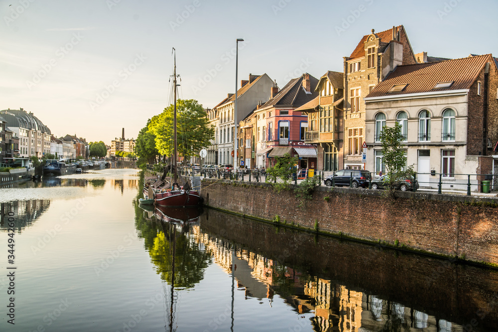 reflection of colorful homes in canal in belgium
