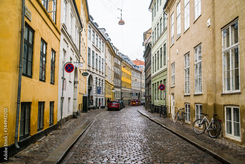 colorful townhomes of Copenhagen Denmark along cobblestone street © Zach
