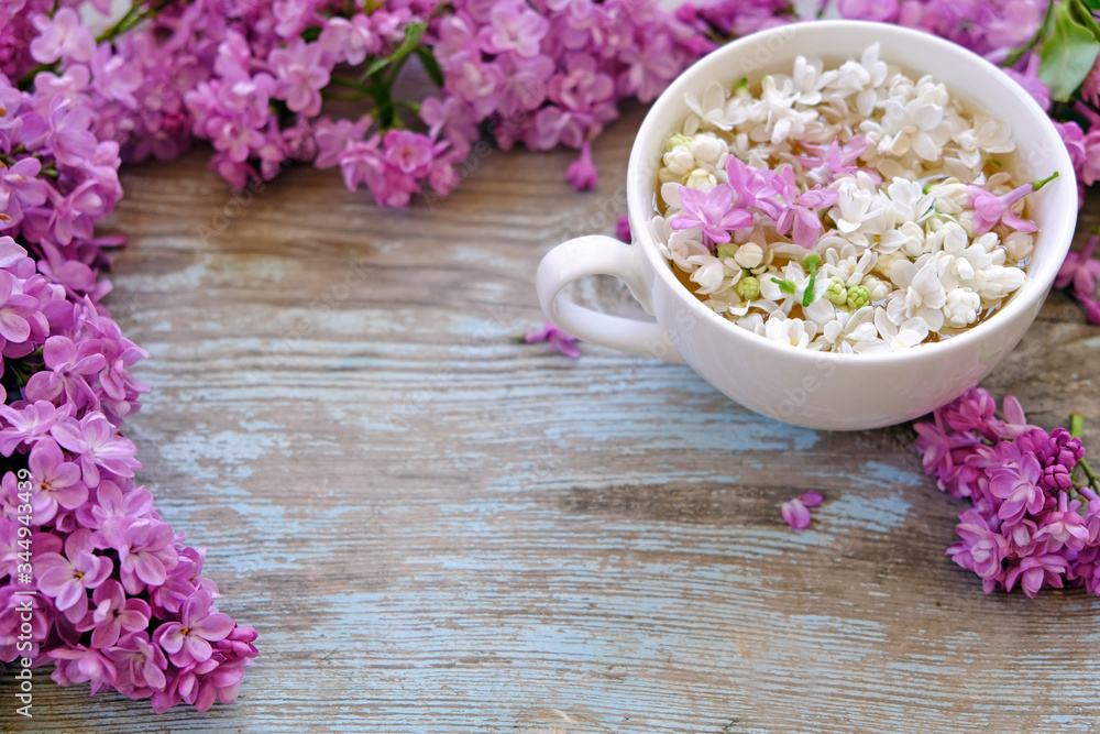 Cup of tea with lilac flowers on wooden background. Spring time. Vase with lilac. Copy space for text. The concept of holidays and good morning wishes.
Cup of tea with lilac flowers on wooden background. Spring time. Vase with lilac. Copy space for text. The concept of holidays and good morning wishes.