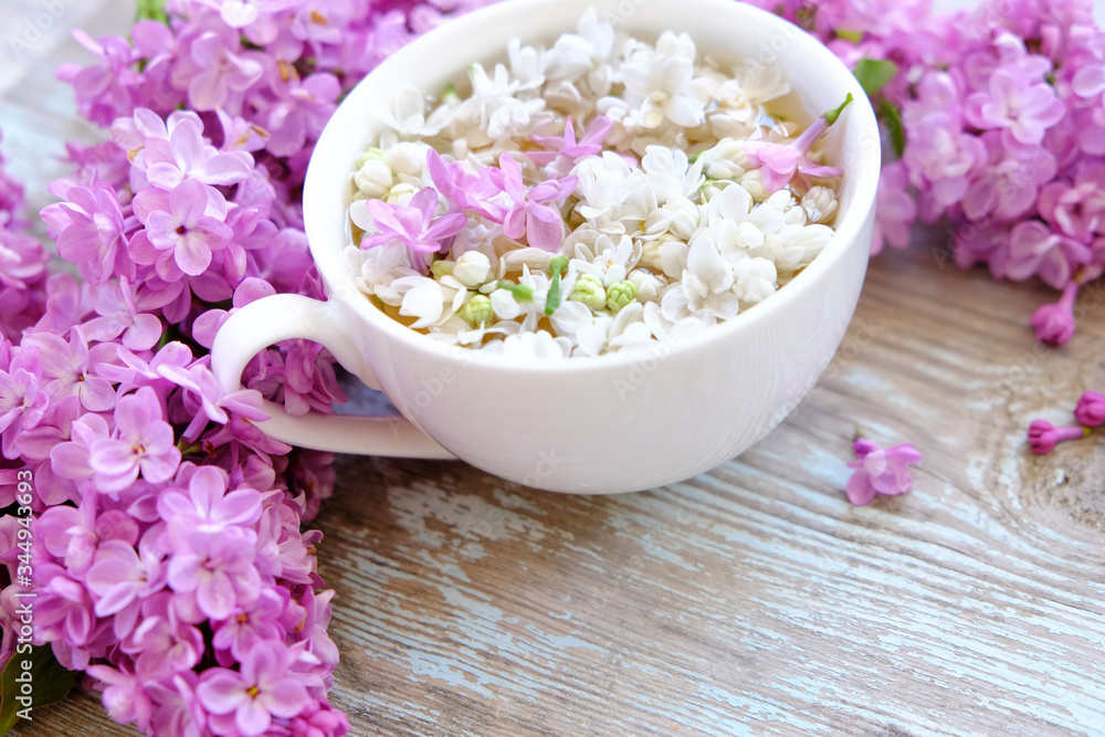Cup of tea with lilac flowers on wooden background. Spring time. Vase with lilac. Copy space for text. The concept of holidays and good morning wishes.
Cup of tea with lilac flowers on wooden background. Spring time. Vase with lilac. Copy space for text. The concept of holidays and good morning wishes.