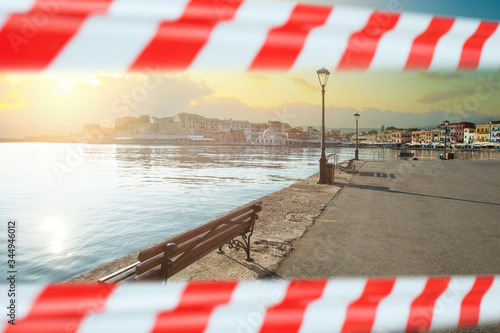 Empty promenade in Chania, Crete, Greece with warning tape photo