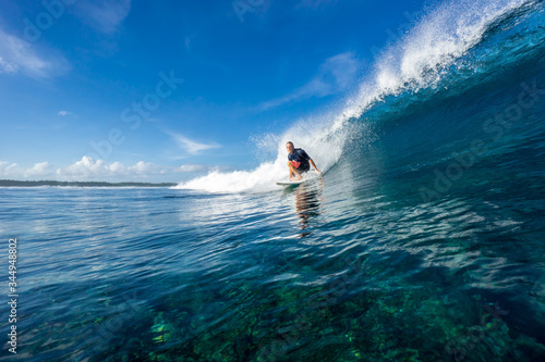 Canvas Print muscular surfer riding on big waves on the Indian Ocean island of Mauritius