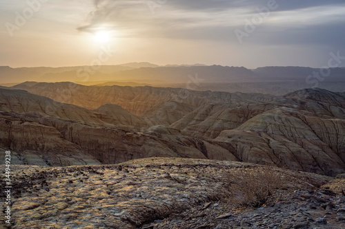 Sunset in the desert area in the mountains. Fancy Sand Canyons. National Park Altyn-Emel. Kazakhstan photo