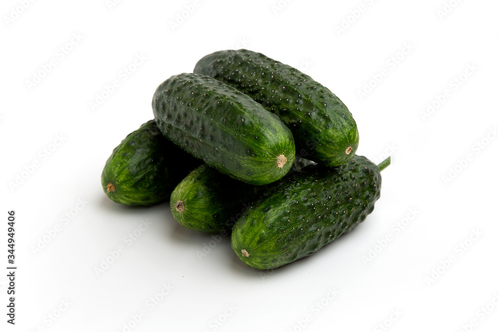 Bright green cucumbers whole isolated on a white background Bright green cucumbers whole isolated on a white background