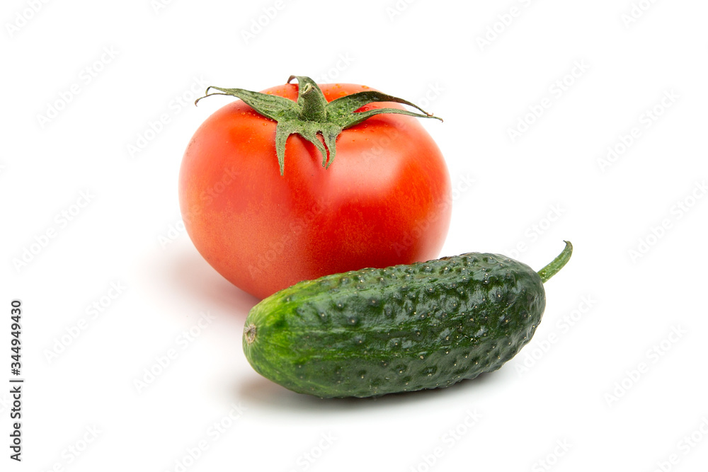 whole juicy bright red tomatoes with green cucumber isolated on a white background whole juicy bright red tomatoes with green cucumber isolated on a white background