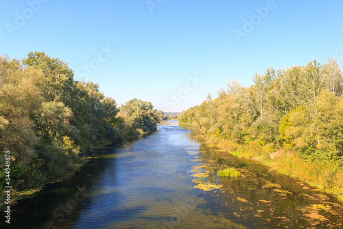 River in the countryside. In the afternoon, before sunset. The concept of nature, water conservation, fresh water conservation. Rural autumn landscape. Ukraine, Europe.