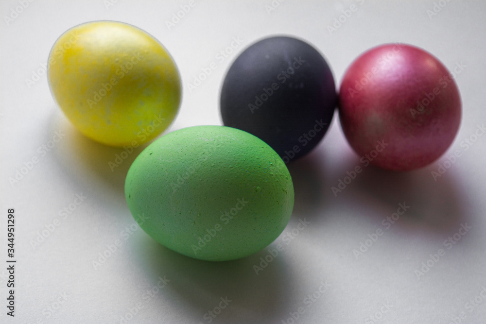 Easter festive multi-colored mother-of-pearl chicken eggs lay on a white background Easter festive multi-colored mother-of-pearl chicken eggs lay on a white background
