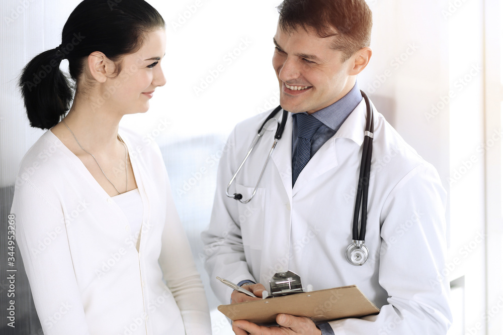Doctor and patient discussing medical exam resoults at hospital office. Physician using clipboard for filling up medication history records. Perfect medical service in clinic. Medicine and healthcare Doctor and patient discussing medical exam resoults at hospital office. Physician using clipboard for filling up medication history records. Perfect medical service in clinic. Medicine and healthcare