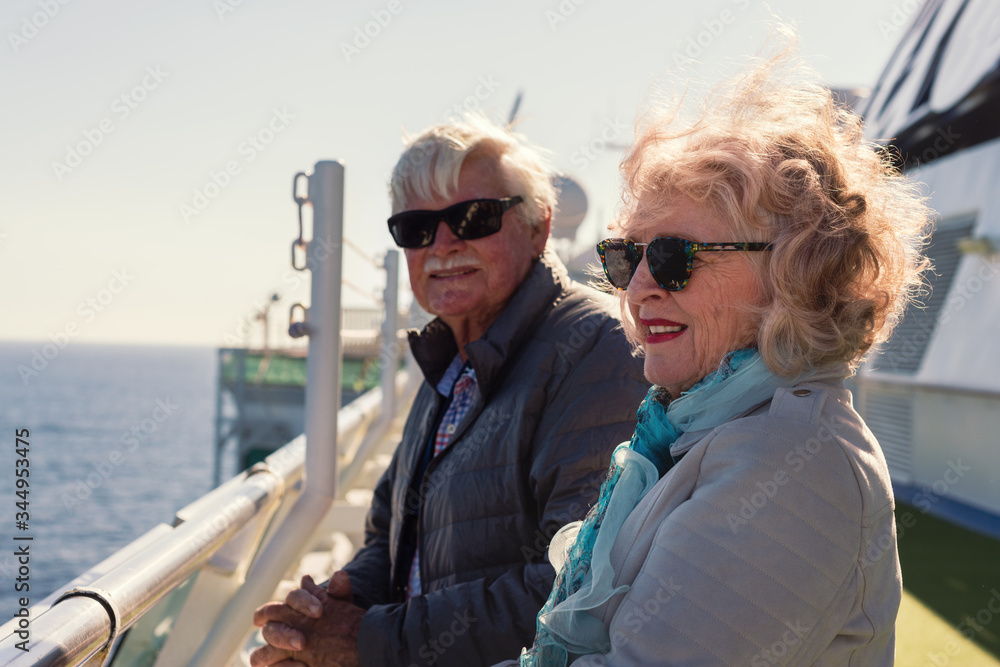 seniors standing outside on the deck of a cruise ship seniors standing outside on the deck of a cruise ship