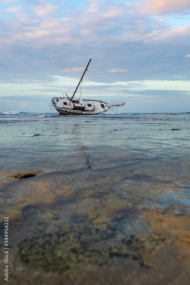 Shipwreck stranded on the coral reef in a tropical beach. Puerto Viejo, Costa Rica Shipwreck stranded on the coral reef in a tropical beach. Puerto Viejo, Costa Rica