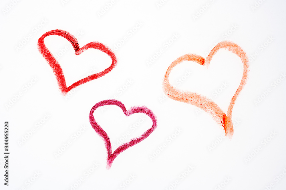 three red hearts drawn with lippstick