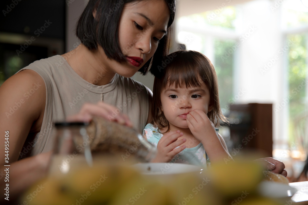 Mom and daughter preparing breakfast together Mom and daughter preparing breakfast together