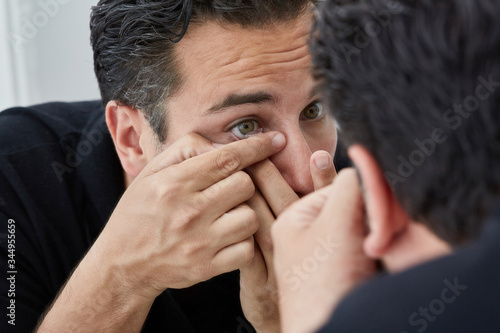 Healthy Mature Man portrait using contact lens in bathroom