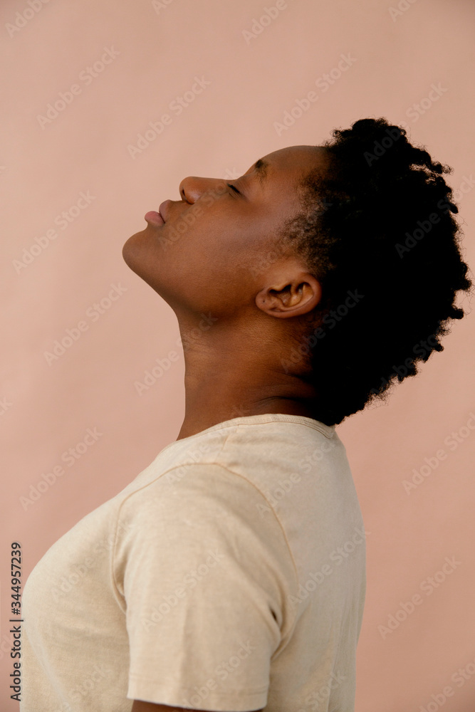 Relaxed black woman tilting up head Relaxed black woman tilting up head