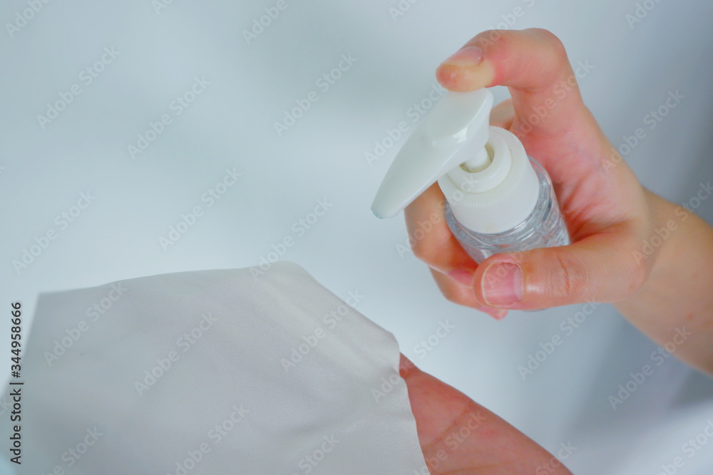 Fototapeta premium Women washing hands with alcohol gel or antibacterial soap sanitizer after using a public car.Hygiene concept. prevent the spread of germs and bacteria and avoid infections corona virus.Close up.