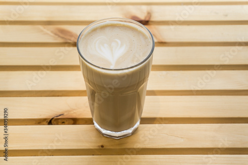 Latte in a cup on a wooden background, product photography
