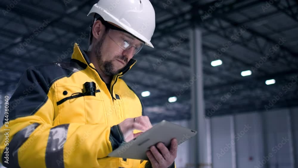 Architect or engineer working, browsing building project indoor of construction site with blueprint plan. businessman worker, man male construction engineers or architects working people. Engineer In Architect or engineer working, browsing building project indoor of construction site with blueprint plan. businessman worker, man male construction engineers or architects working people. Engineer In