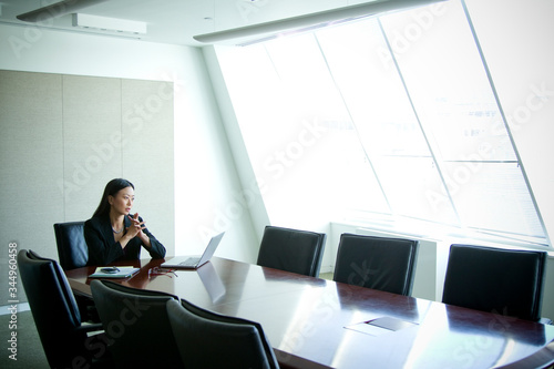 Thoughtful businesswoman sitting in conference room