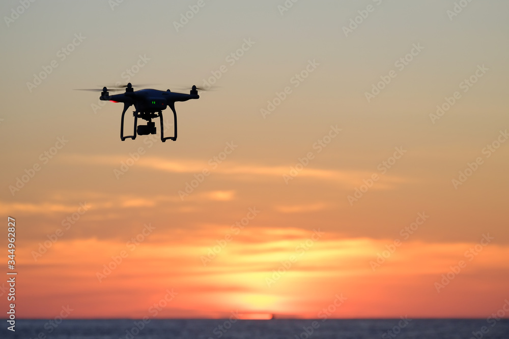 Drone quadcopter at sunset Drone quadcopter at sunset