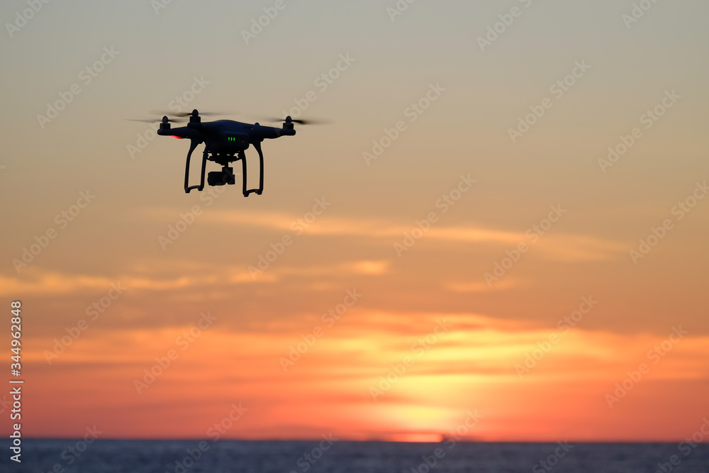 Drone quadcopter at sunset