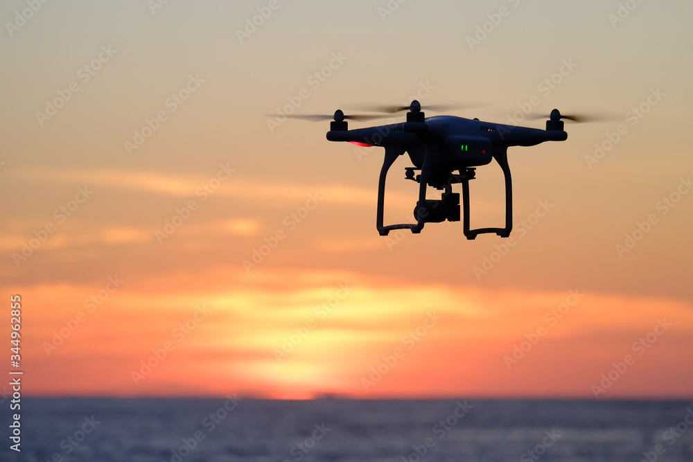 Drone quadcopter at sunset Drone quadcopter at sunset