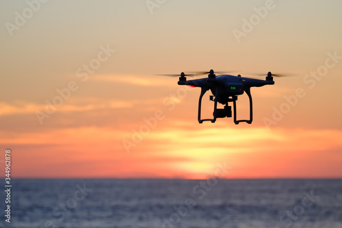 Drone quadcopter at sunset