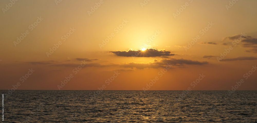 Naples,Florida,USA-05/26/2019. A sunset on the Gulf of Mexico. Horizon line of the water. Naples,Florida,USA-05/26/2019. A sunset on the Gulf of Mexico. Horizon line of the water.