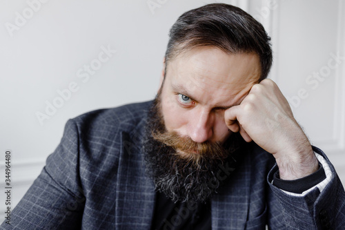 Close-up portrait of a sad businessman in a suit.