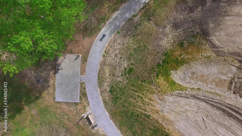 baby on bike rides along the path in the Park, the view from the drone