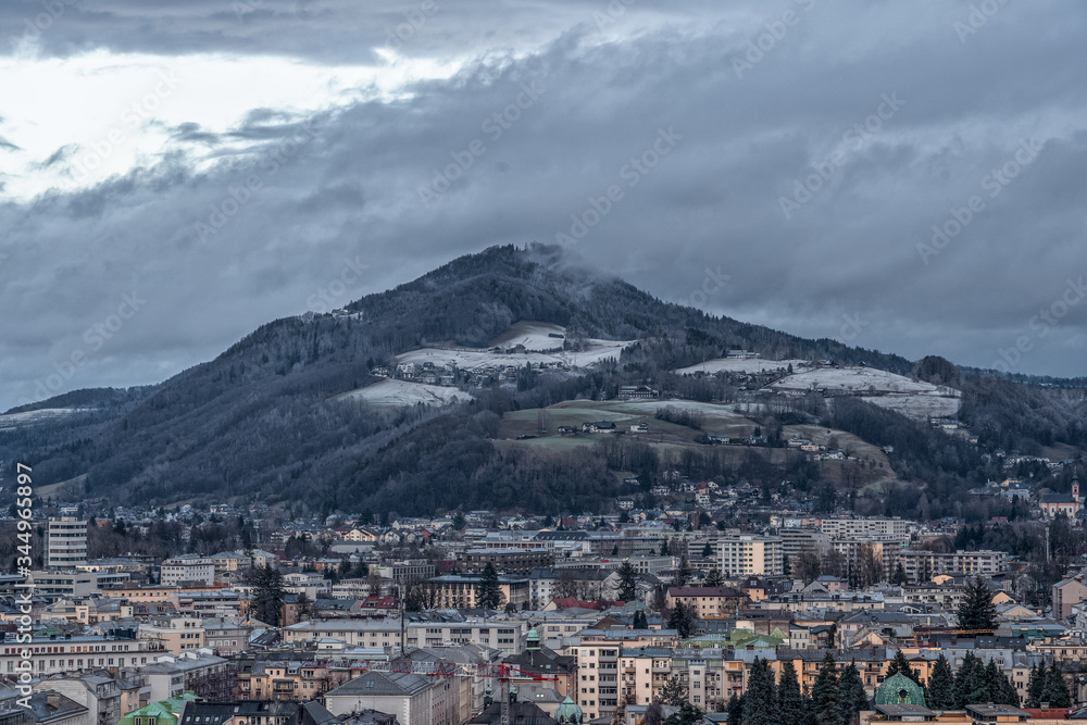 Hills with snow and fog in overcast winter in Salzburg Austria