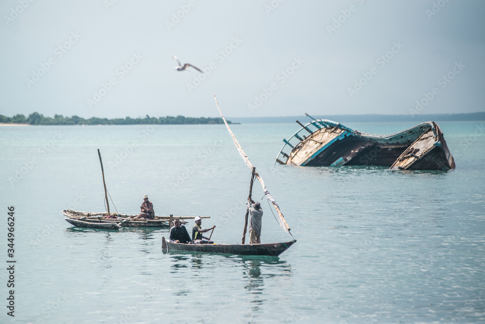 shipwreck behind boats off the coast of zanzibar