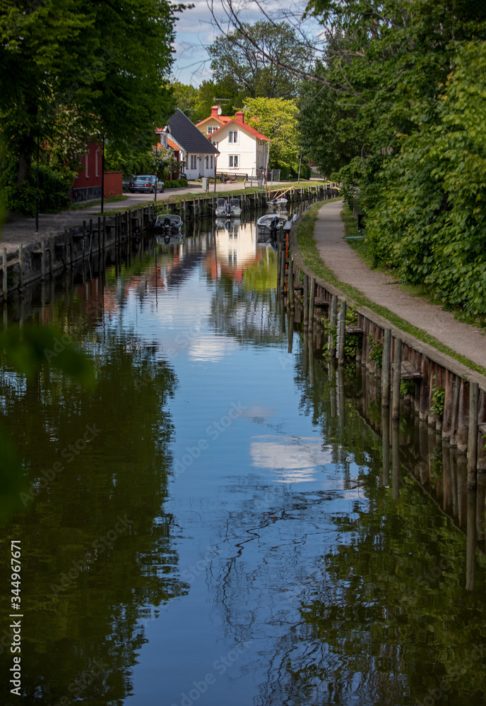 Fototapeta premium Trosa. Canal in the center of the town surrounded by trees