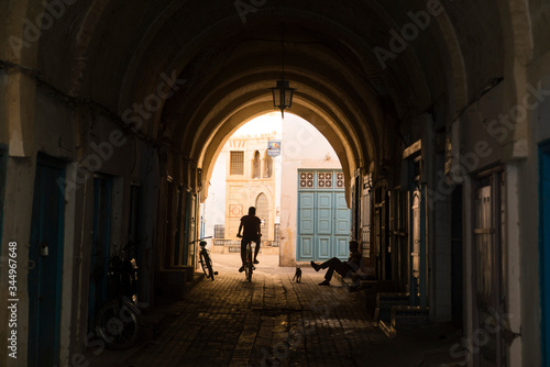 silhouette of a biker in old town tunisia