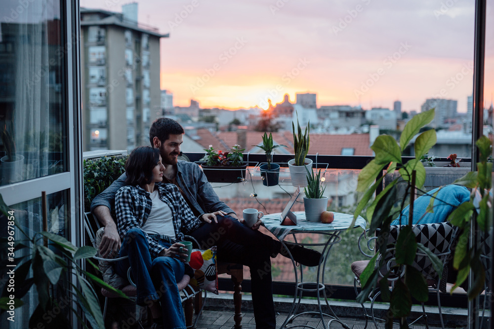 Cute couple looking at table computer on the house terrace Cute couple looking at table computer on the house terrace