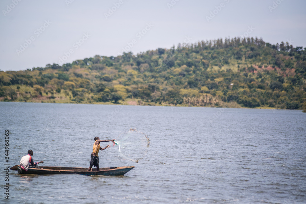 fisherman casting his net on lake victoria uganda