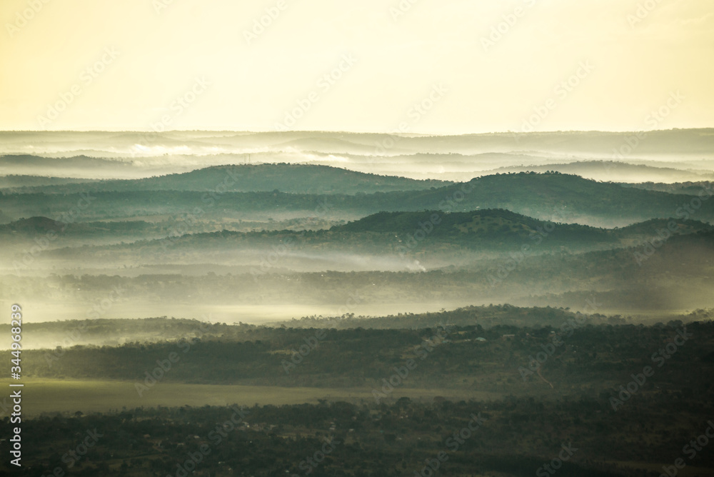 Obraz premium hazy morning light over mountain ridges in africa