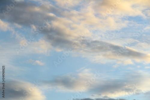 Fototapeta Naklejka Na Ścianę i Meble -  Clouds in the blue sky at sunset or dawn backlit by the sun. Place for text and design.