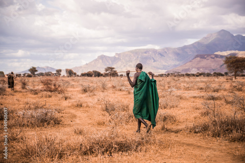 tribal african warrior walking along the plains of uganda photo